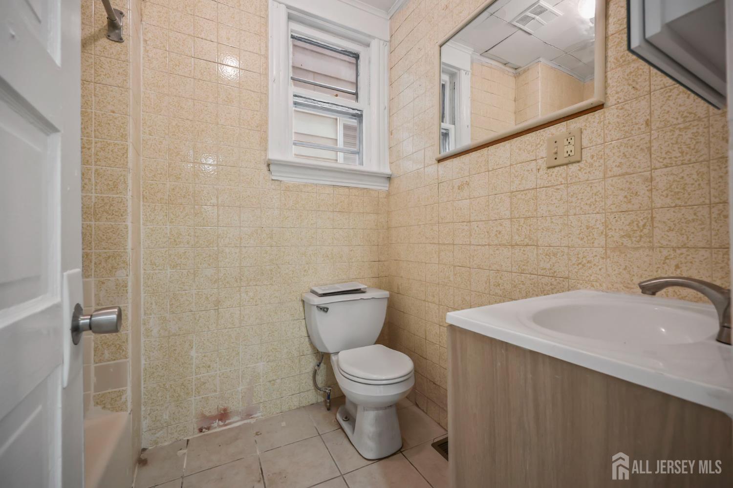 264 Barclay Street Perth Amboy, NJ 08861 - Photo 11 of 45 a bathroom with a toilet a sink and a shower