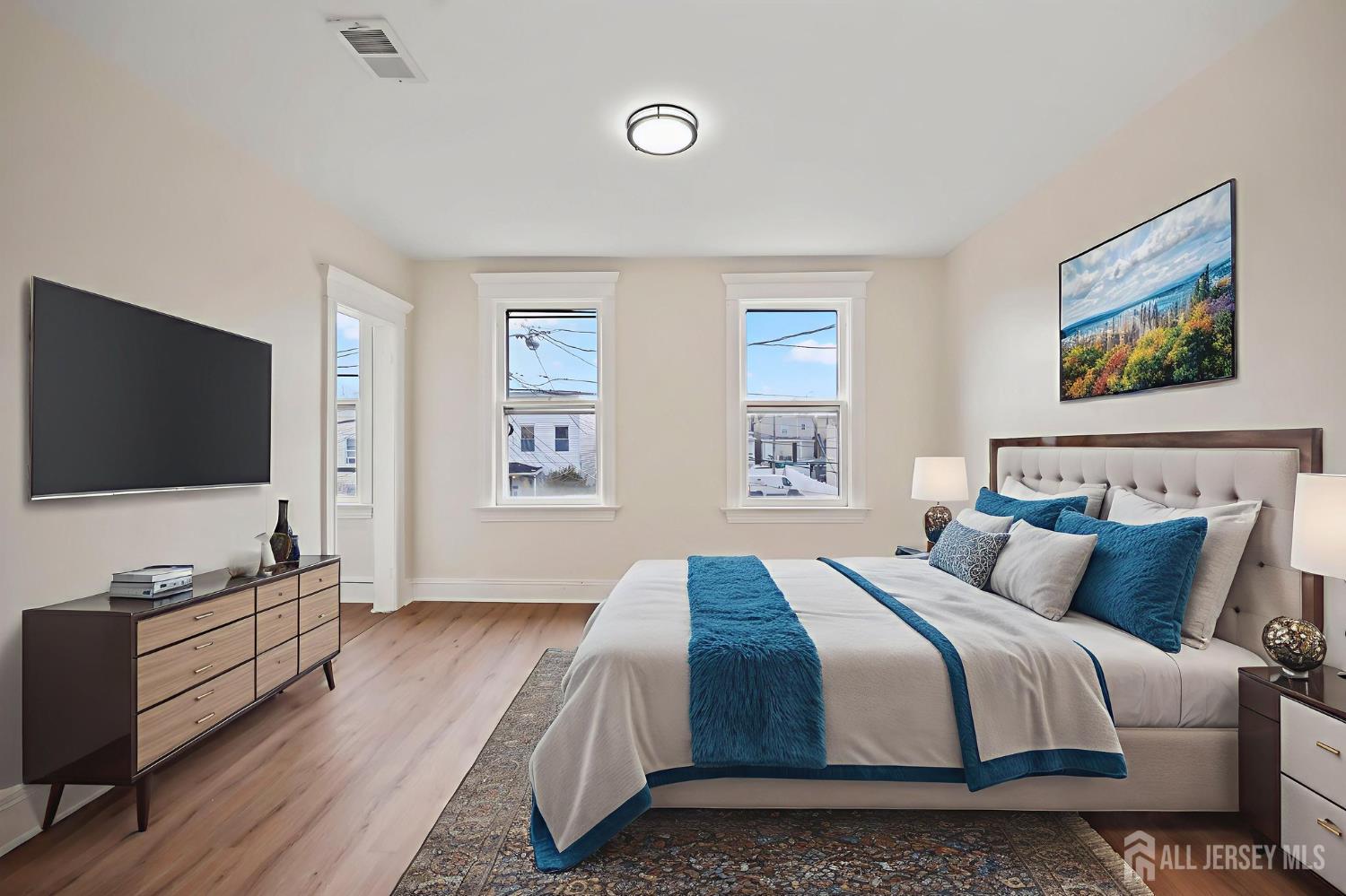 264 Barclay Street Perth Amboy, NJ 08861 - Photo 22 of 45 a bedroom with a bed and a flat screen tv