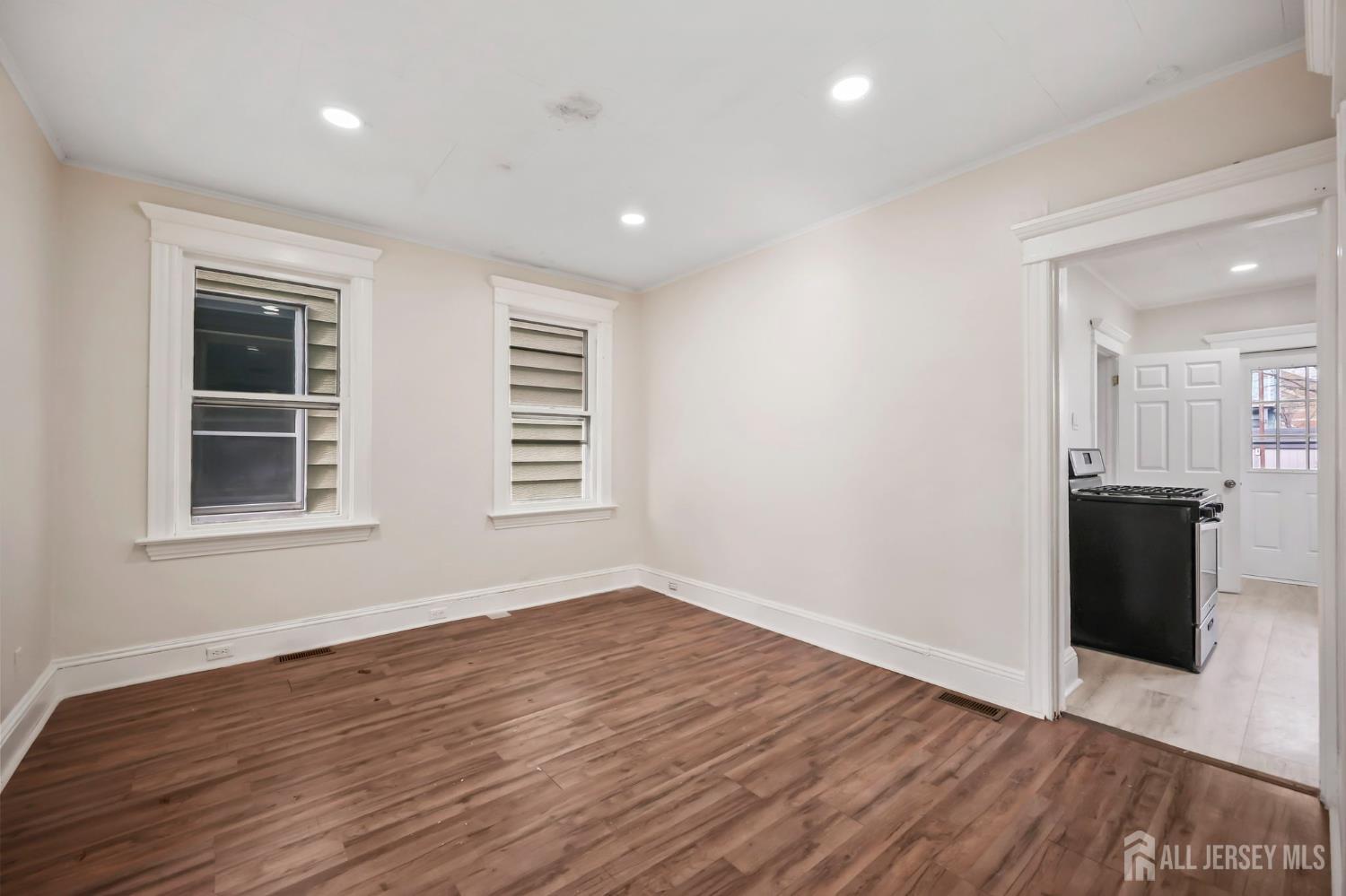 264 Barclay Street Perth Amboy, NJ 08861 - Photo 8 of 45 a view of empty room with wooden floor and windows
