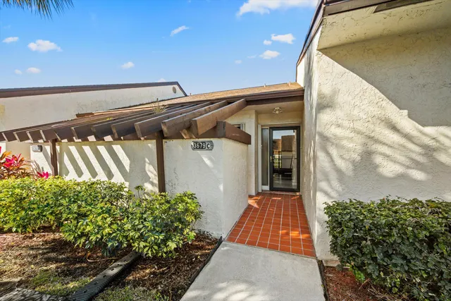 an aerial view of a residential houses with yard