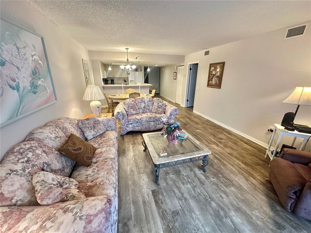 6035 Sea Ranch Drive, Unit 410 Hudson, FL 34667 - Photo 12 of 64 a living room with furniture and a wooden floor