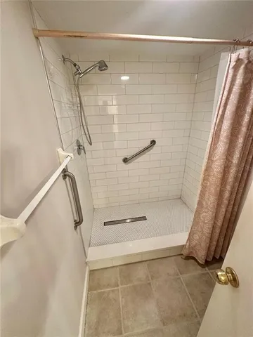 a bedroom with a bed and closet with mirror