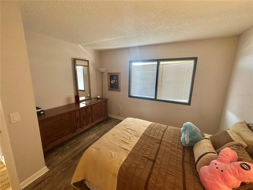 6035 Sea Ranch Drive, Unit 410 Hudson, FL 34667 - Photo 20 of 64 a bedroom with a bed and closet with mirror