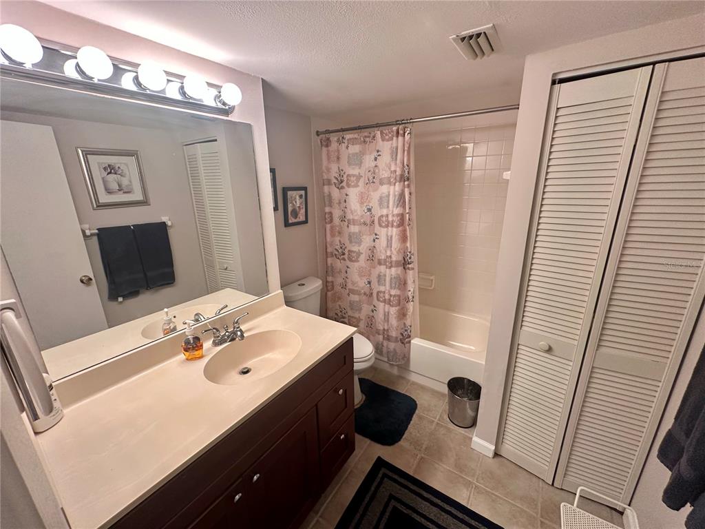 6035 Sea Ranch Drive, Unit 410 Hudson, FL 34667 - Photo 21 of 64 a bathroom with a sink a toilet a mirror and shower