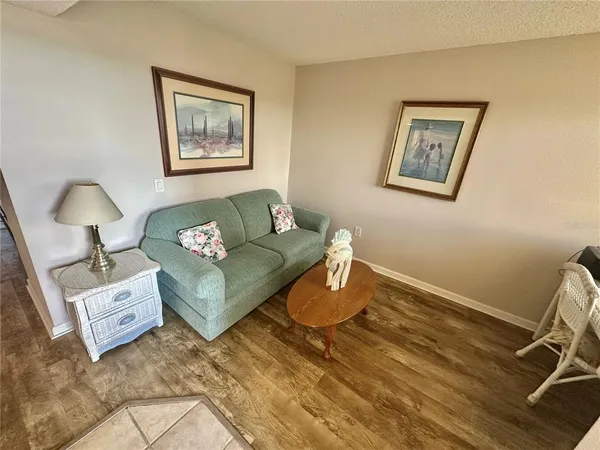 a view of a chairs and table in wooden floor