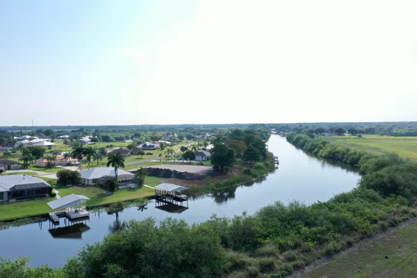 an aerial view of a lake with residential houses with outdoor space