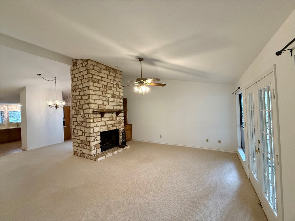 8 Stonehouse Circle Wimberley, TX 78676 - Photo 17 of 18 an empty room with fireplace and windows