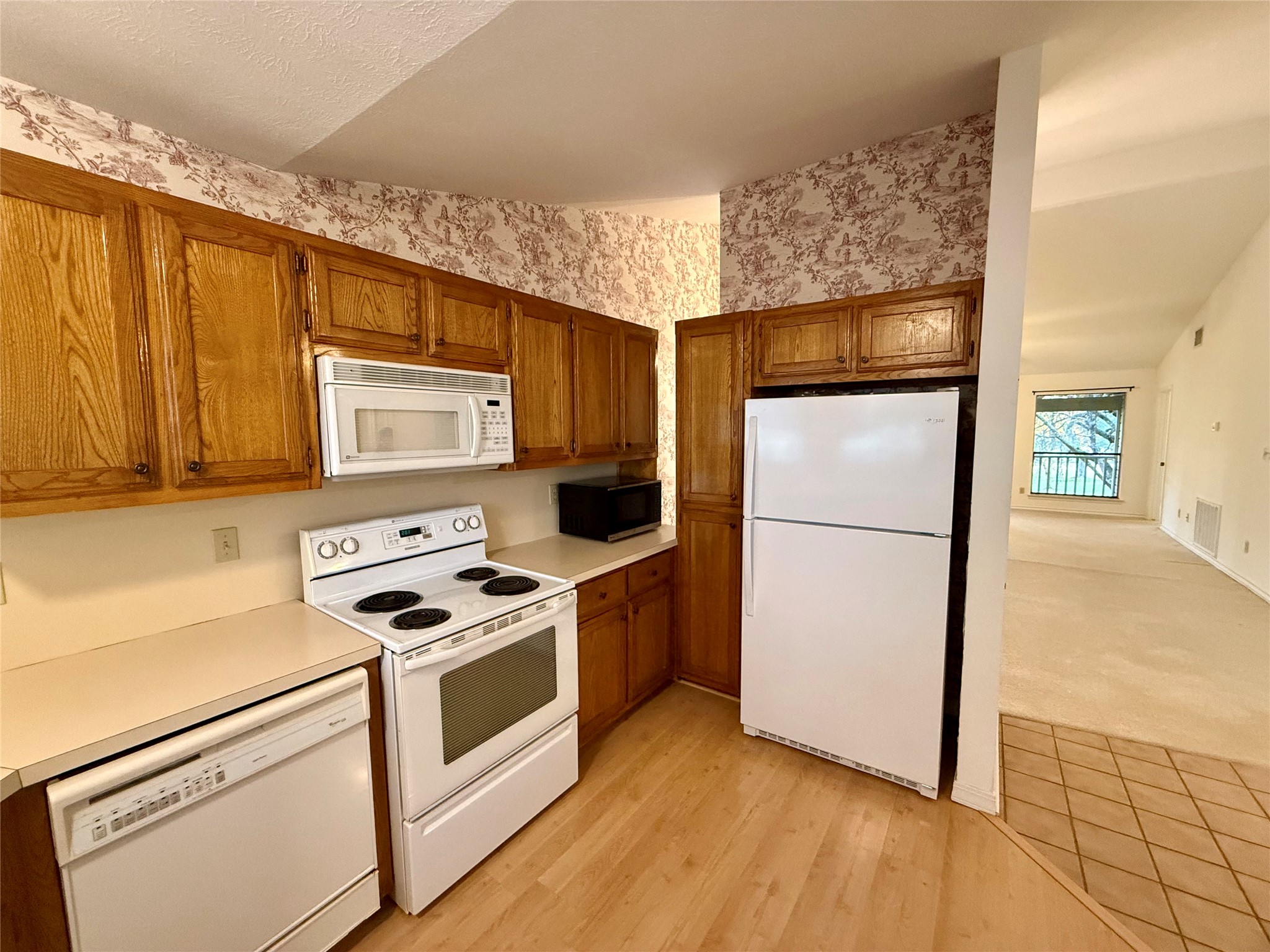 8 Stonehouse Circle Wimberley, TX 78676 - Photo 7 of 18 a kitchen with a refrigerator sink and cabinets