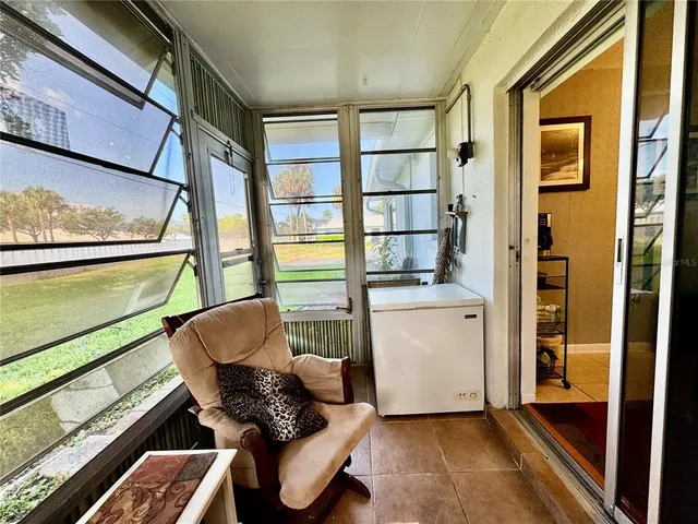 a view of a house with a yard and sitting area