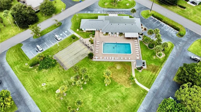 a room with lots of wooden furniture and a potted plant