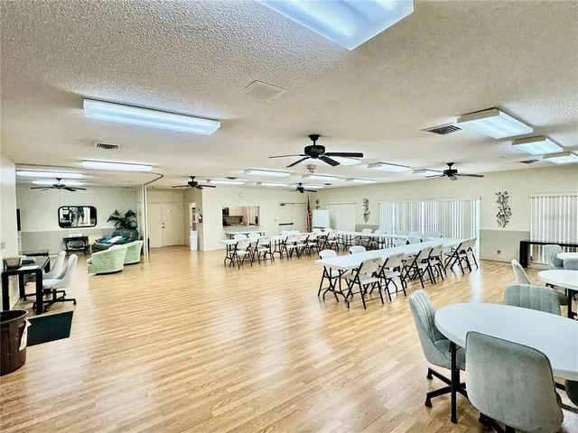 a living room with furniture and large windows