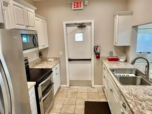 a front view of house with yard and car parked