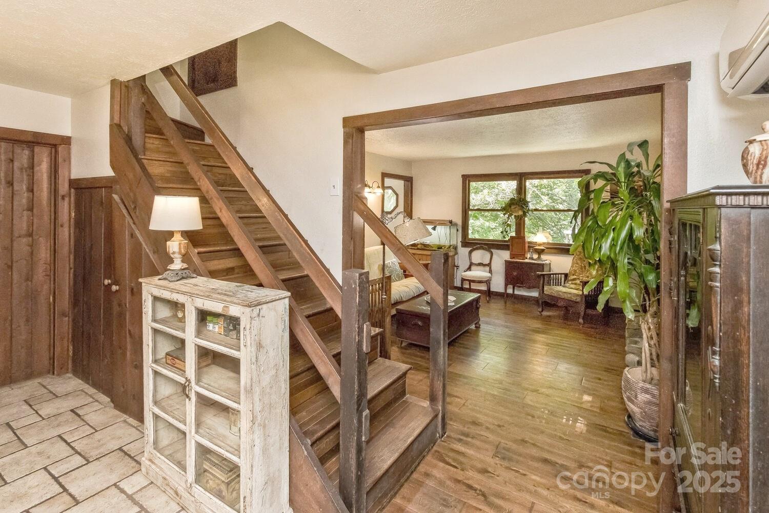 557 Tumbling Fork Road Waynesville, NC 28785 - Photo 12 of 44 a view of an entryway with wooden floor and a livingroom