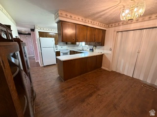 588 North 4500 West West Point, UT 84015 - Photo 14 of 61 Kitchen featuring wood-finish flooring, dark wood cabinetry, white countertops, and white appliances