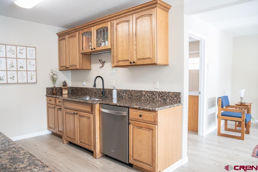 490 6403 Road Montrose, CO 81403 - Photo 11 of 40 a kitchen with stainless steel appliances granite countertop a stove a sink and a microwave