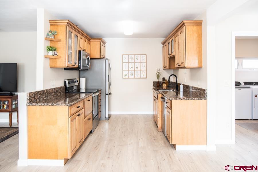490 6403 Road Montrose, CO 81403 - Photo 12 of 40 a kitchen with stainless steel appliances granite countertop a stove a sink a refrigerator and a microwave
