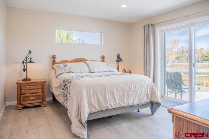 490 6403 Road Montrose, CO 81403 - Photo 19 of 40 a bed sitting in a bedroom next to a window