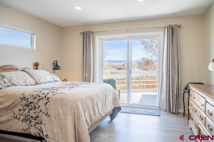 490 6403 Road Montrose, CO 81403 - Photo 20 of 40 a bedroom with a bed and a large window