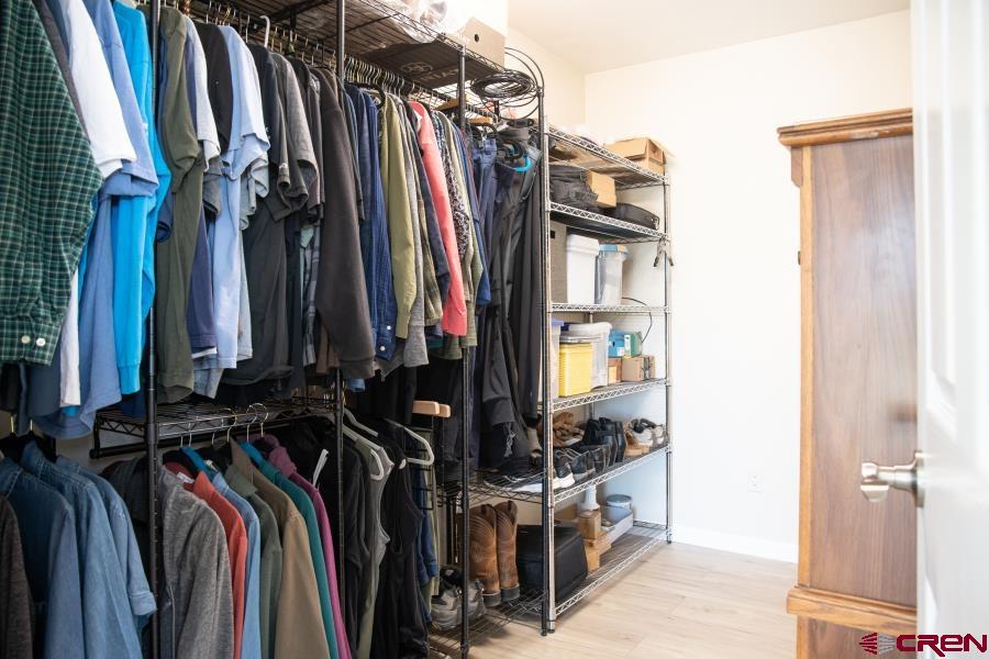 490 6403 Road Montrose, CO 81403 - Photo 23 of 40 a view of walk in closet with clothes