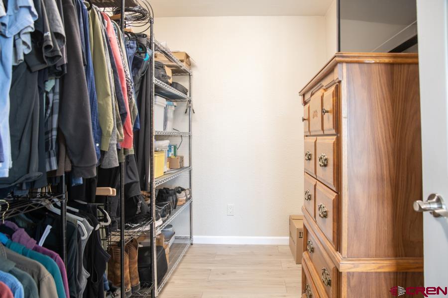 490 6403 Road Montrose, CO 81403 - Photo 24 of 40 a view of walk in closet with clothes