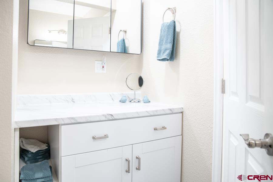490 6403 Road Montrose, CO 81403 - Photo 26 of 40 a bathroom with a sink and a mirror