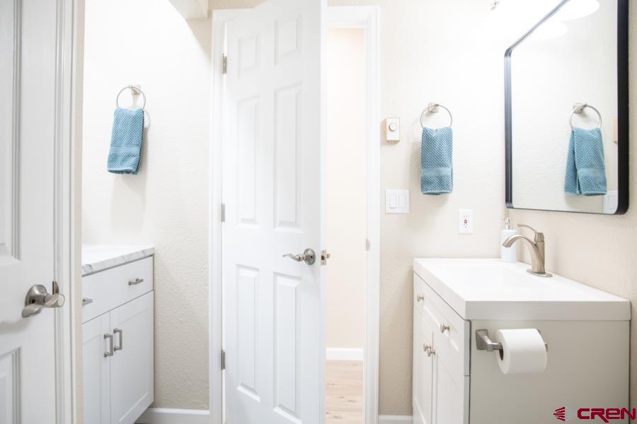 490 6403 Road Montrose, CO 81403 - Photo 27 of 40 a bathroom with a sink and mirror