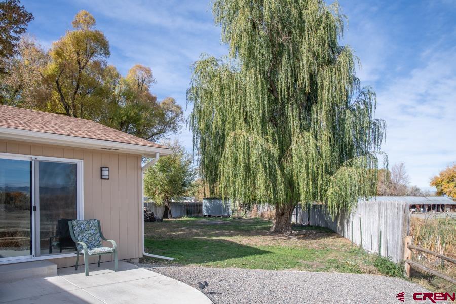 490 6403 Road Montrose, CO 81403 - Photo 33 of 40 a view of a patio with a table and chairs under an umbrella