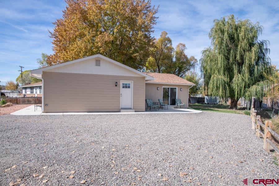 490 6403 Road Montrose, CO 81403 - Photo 34 of 40 a front view of a house with a yard and garage