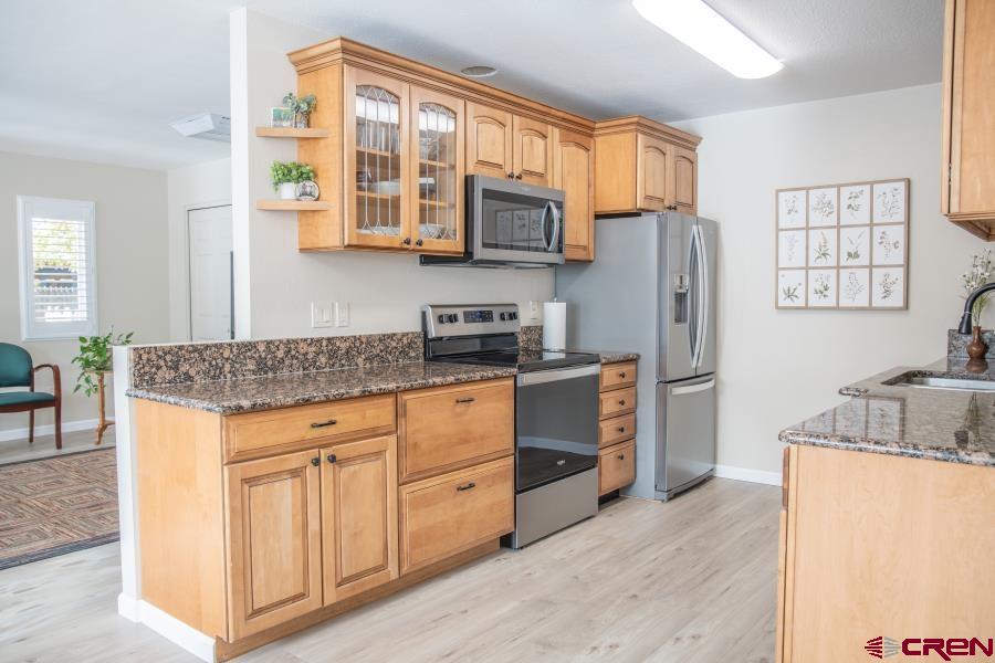 490 6403 Road Montrose, CO 81403 - Photo 10 of 40 a kitchen with stainless steel appliances granite countertop a refrigerator and a stove top oven