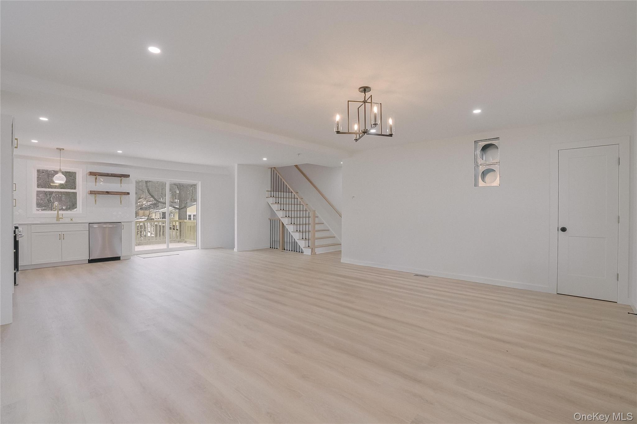 17 Maple Street Beacon, NY 12508 - Photo 15 of 39 a view of an empty room with wooden floor and kitchen view