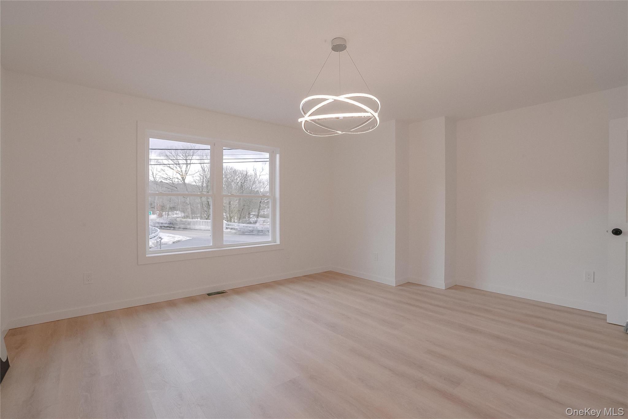 17 Maple Street Beacon, NY 12508 - Photo 20 of 38 Empty room featuring a chandelier and light wood finished floors