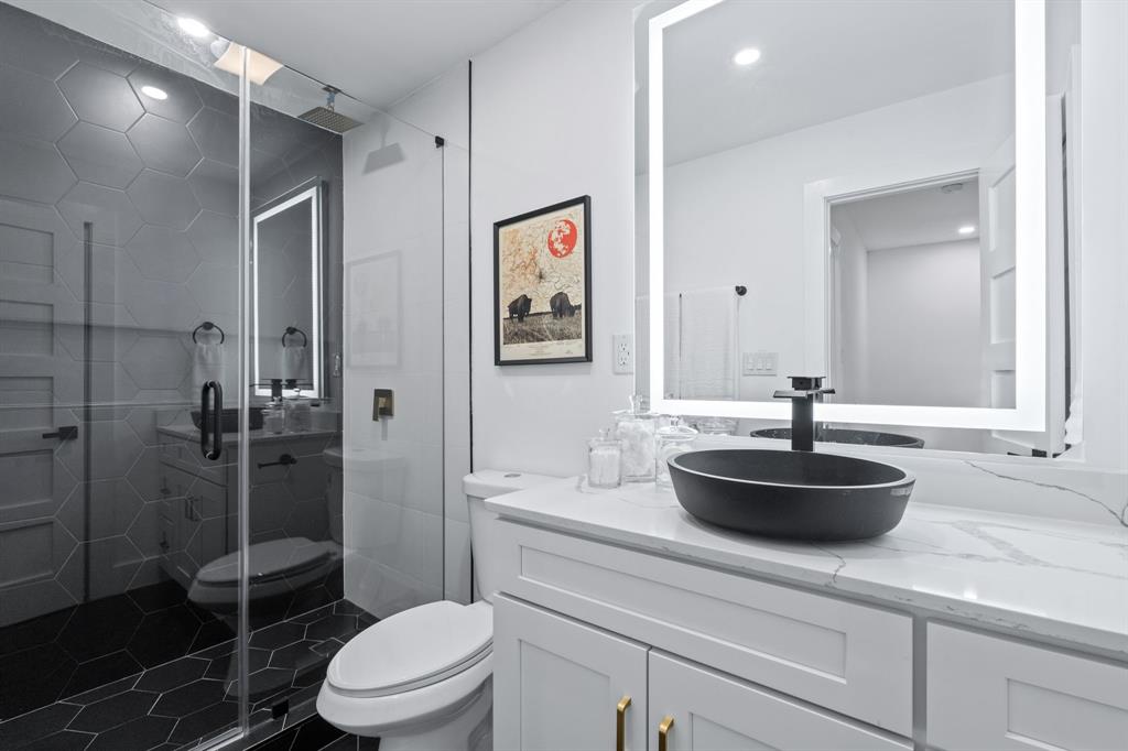 2706 Wheless Lane, Unit 401 Austin, TX 78723 - Photo 15 of 24 A modern bathroom showcases a spacious walk-in shower and elegant floating vanity.