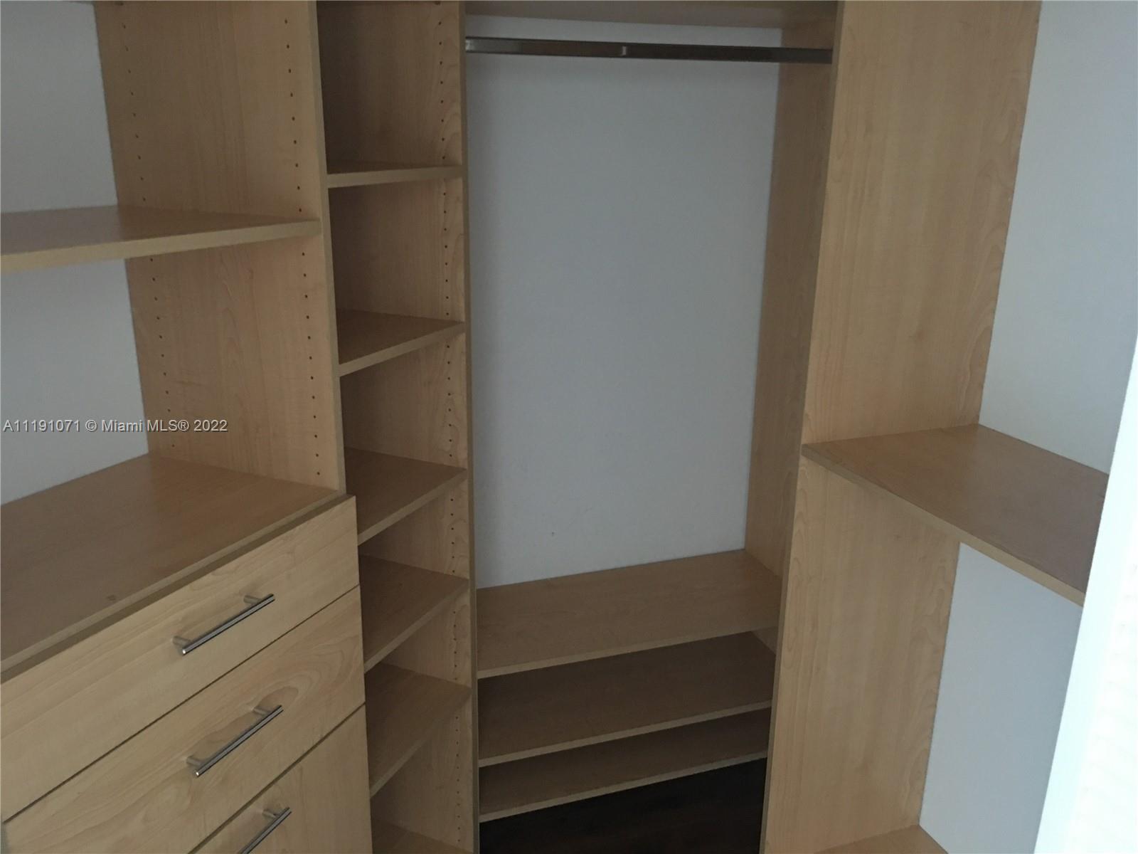 701 Brickell Key Boulevard, Unit 1502 Miami, FL 33131 - Photo 8 of 21 a view of walk in closet with empty racks