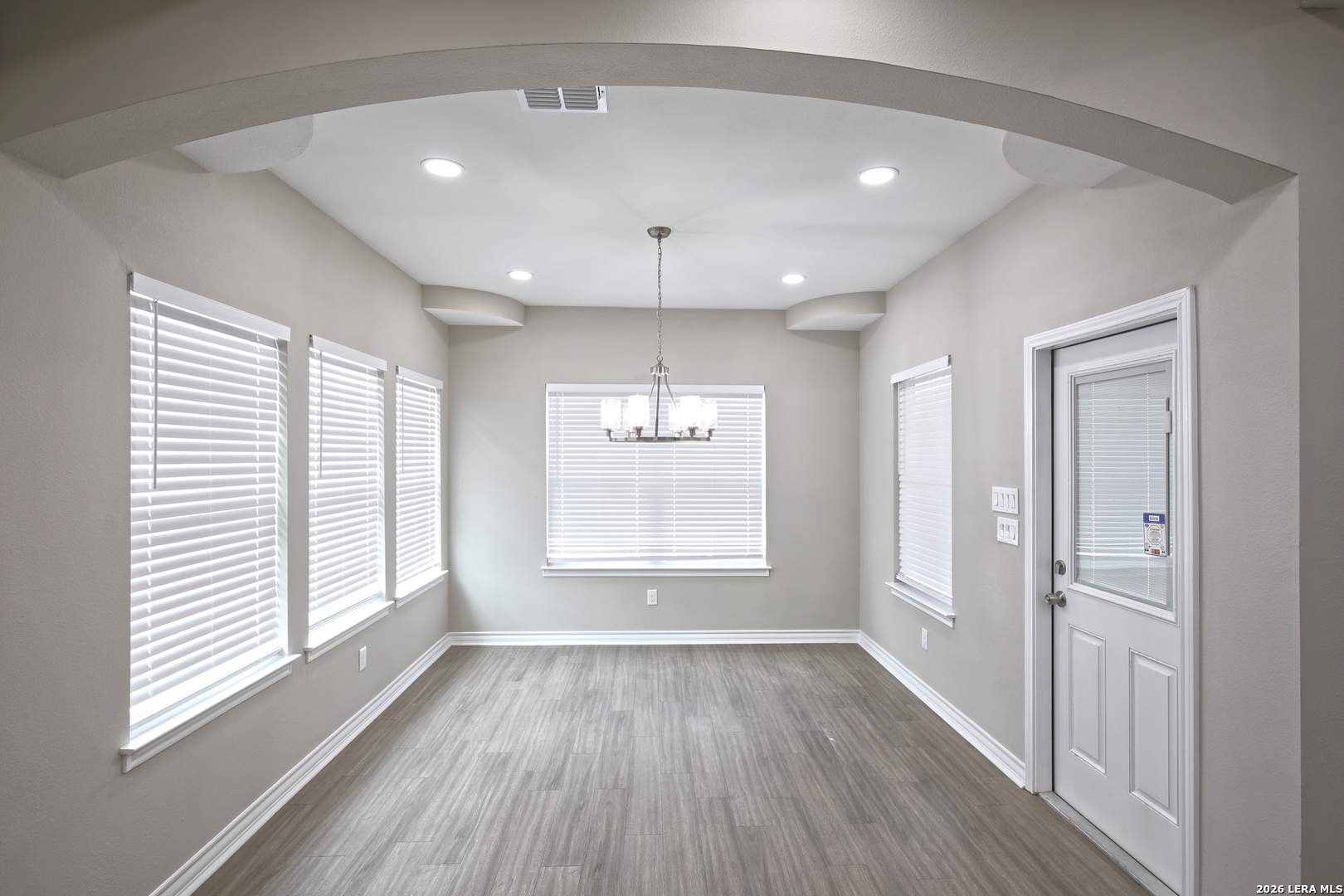 918 Marbach Road Somerset, TX 78069 - Photo 12 of 36 a view of an empty room with wooden floor and a window