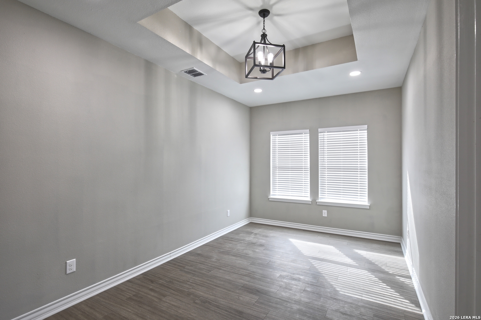 918 Marbach Road Somerset, TX 78069 - Photo 16 of 36 an empty room with wooden floor and windows