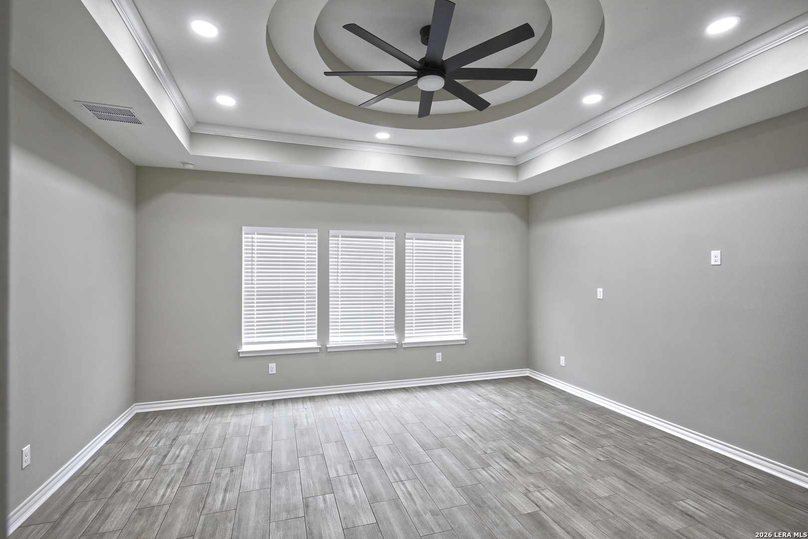918 Marbach Road Somerset, TX 78069 - Photo 18 of 36 a view of empty room with wooden floor and fan