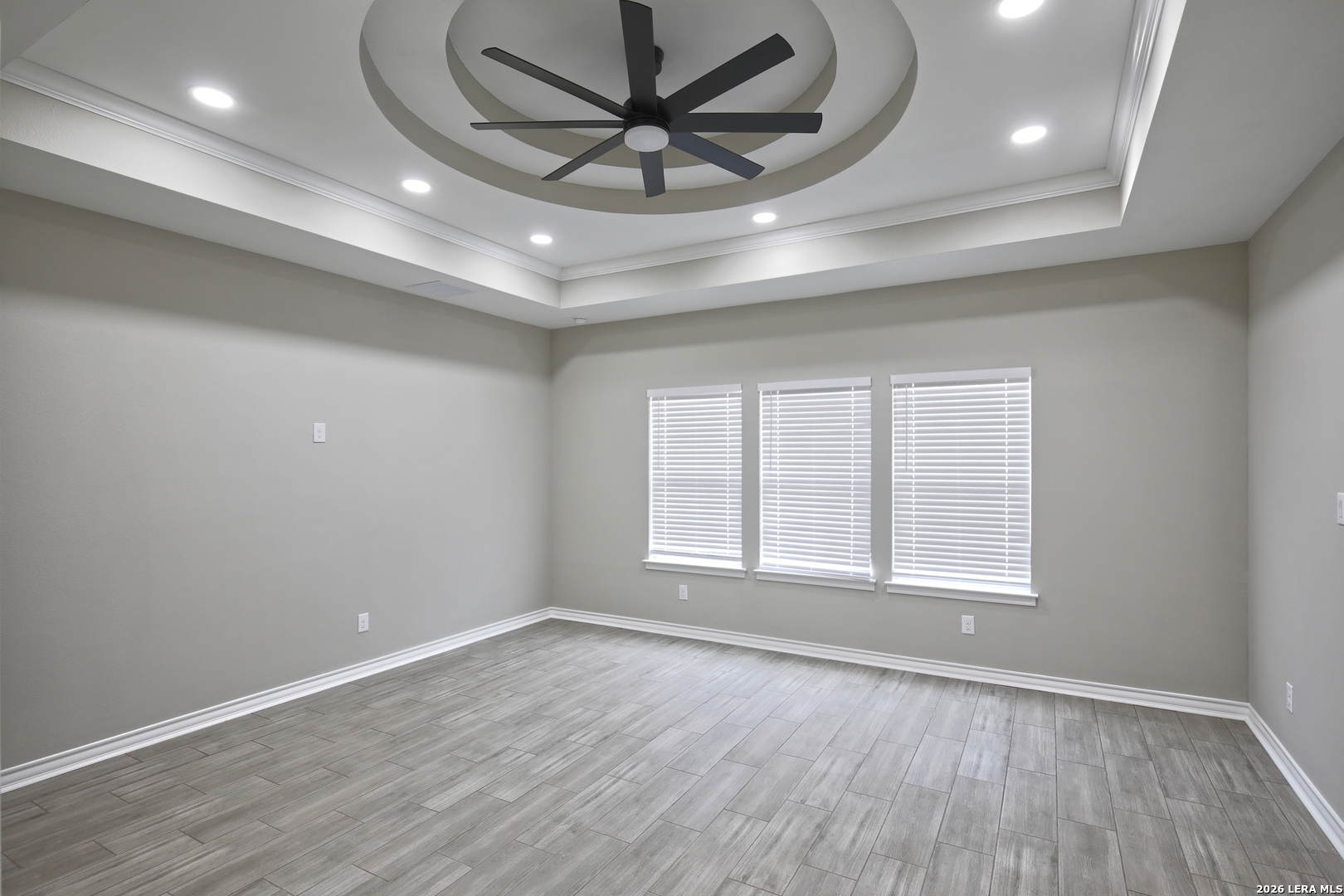 918 Marbach Road Somerset, TX 78069 - Photo 22 of 36 an empty room with wooden floor and windows