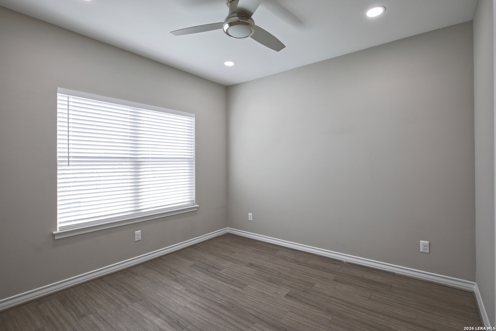 918 Marbach Road Somerset, TX 78069 - Photo 25 of 36 an empty room with a window and wooden floor