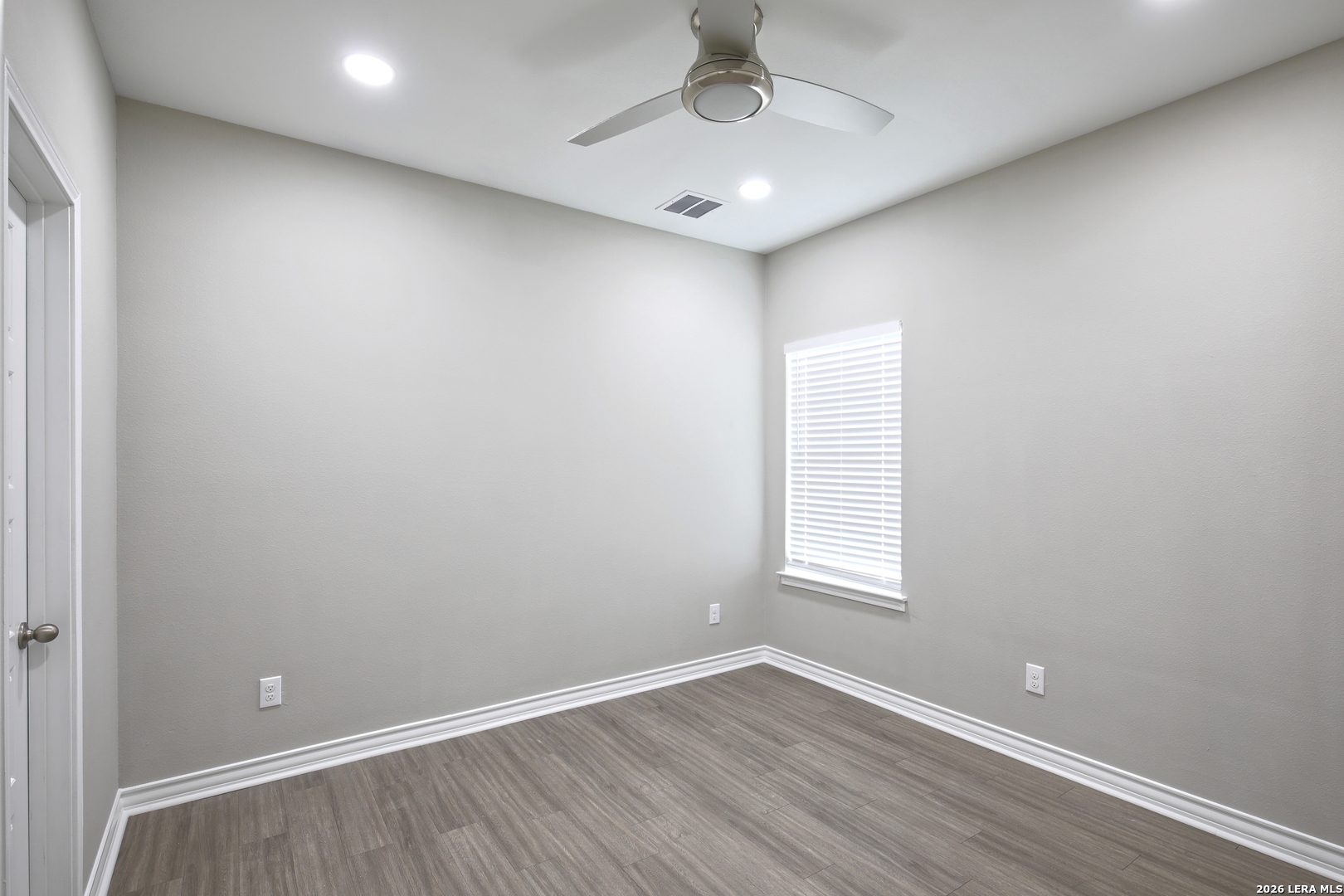 918 Marbach Road Somerset, TX 78069 - Photo 27 of 36 an empty room with wooden floor and windows