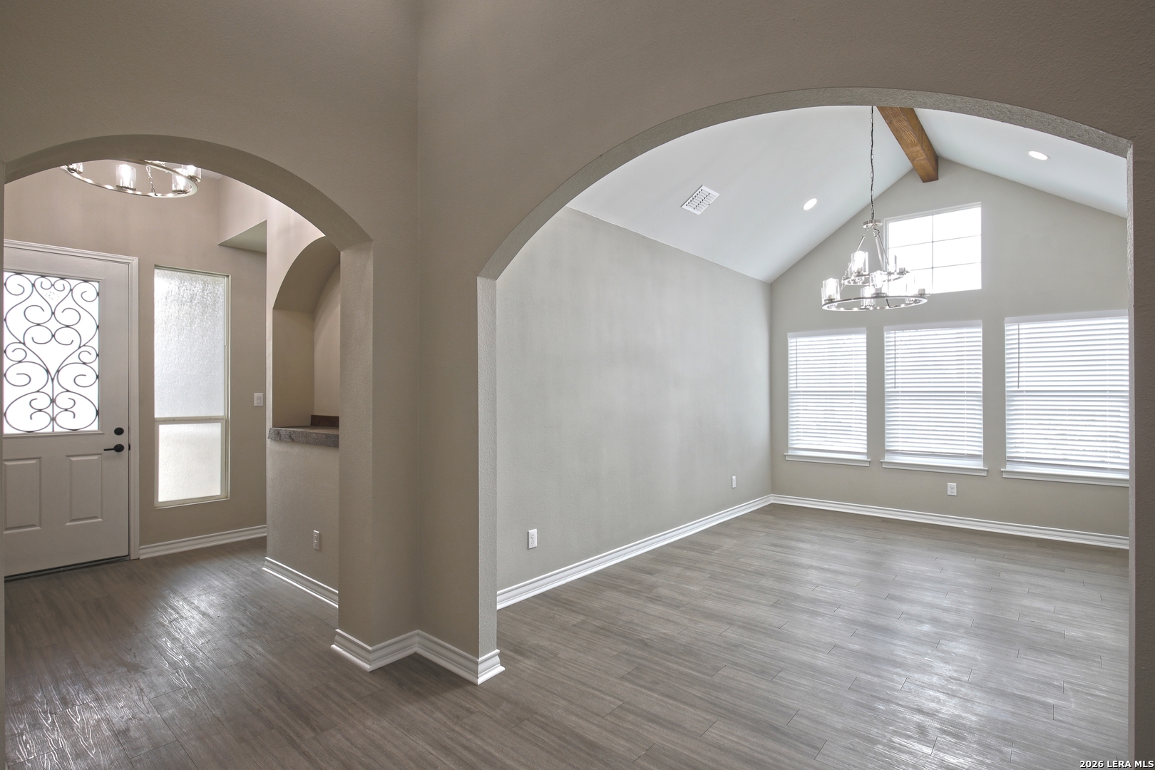 918 Marbach Road Somerset, TX 78069 - Photo 5 of 36 an empty room with wooden floor and windows
