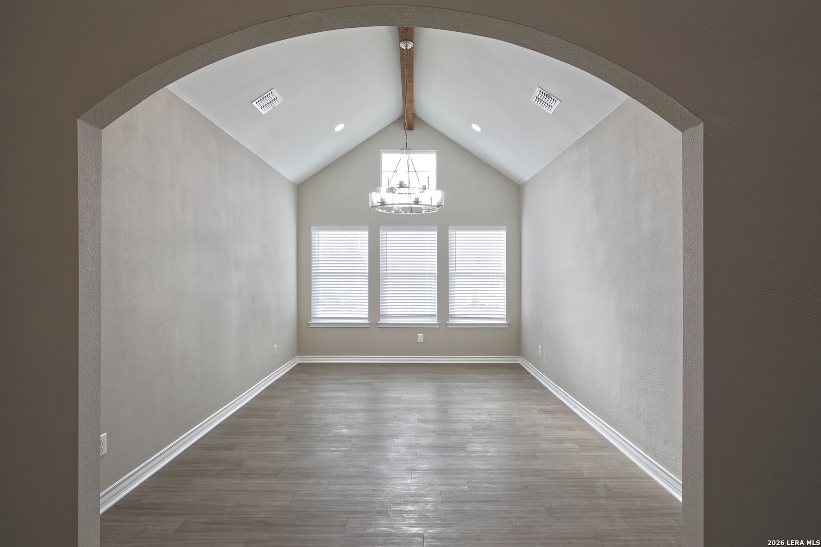 918 Marbach Road Somerset, TX 78069 - Photo 6 of 36 an empty room with wooden floor and windows
