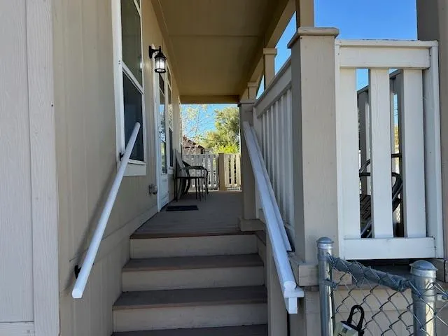 a view of staircase with lots of frames on wall and a window
