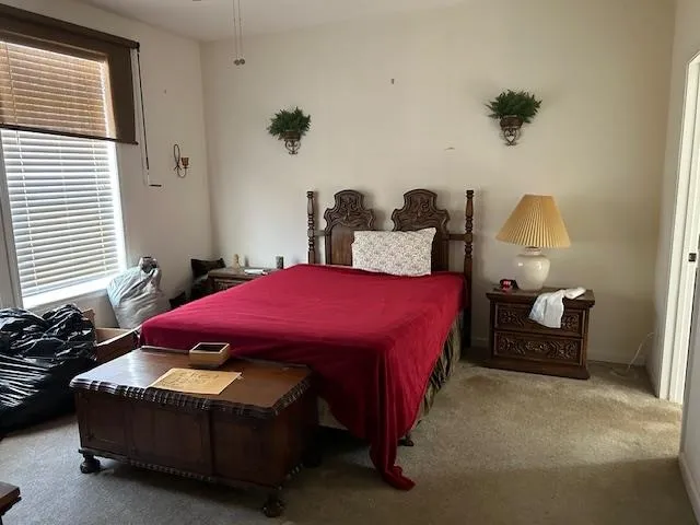 a bed room with a bed and a lamp