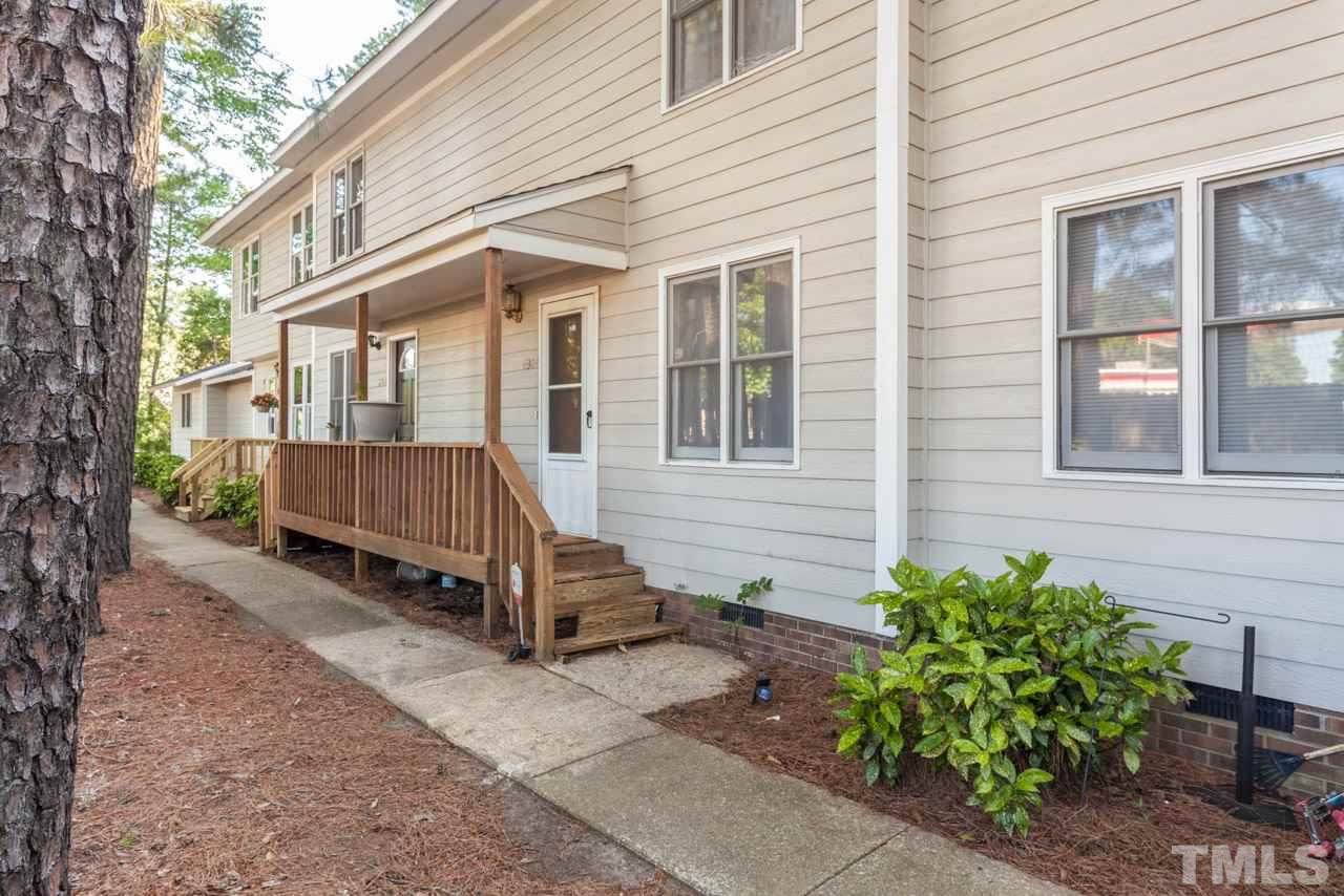 6904 Falls Of Neuse Road, Unit 6904 Raleigh, NC 27615 - Photo 2 of 23 a view of a house with a yard and wooden fence