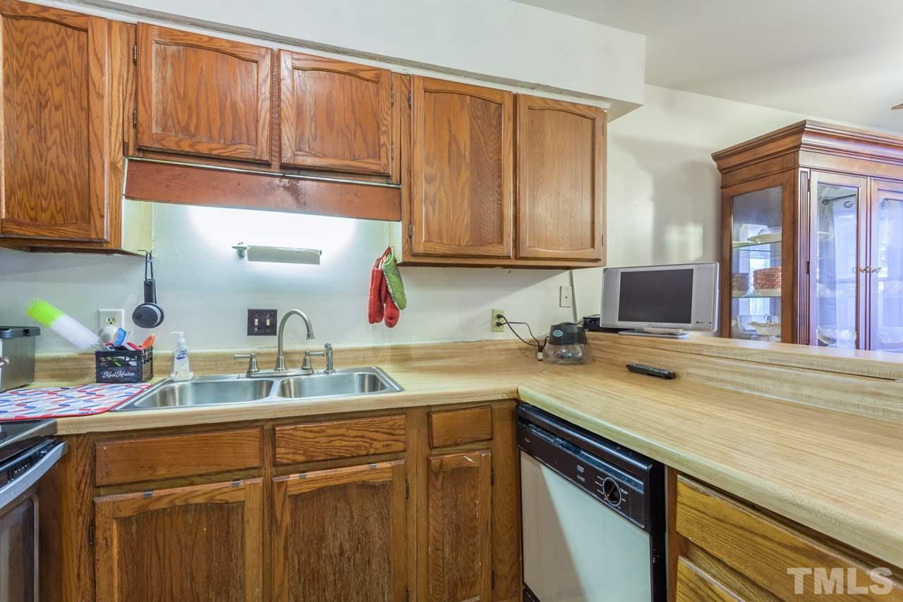 6904 Falls Of Neuse Road, Unit 6904 Raleigh, NC 27615 - Photo 11 of 23 a kitchen with a sink cabinets and window