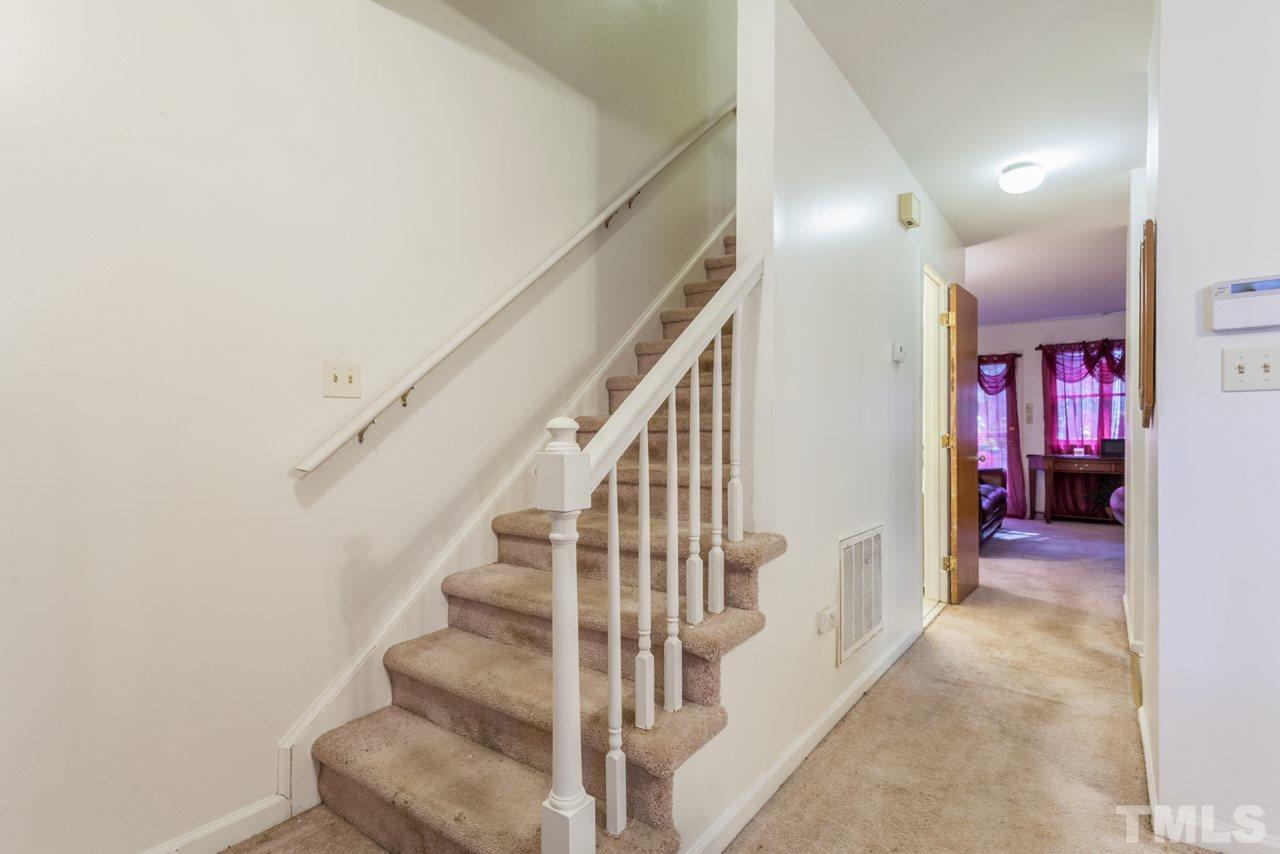 6904 Falls Of Neuse Road, Unit 6904 Raleigh, NC 27615 - Photo 13 of 23 a view of staircase with lots of frames and chairs