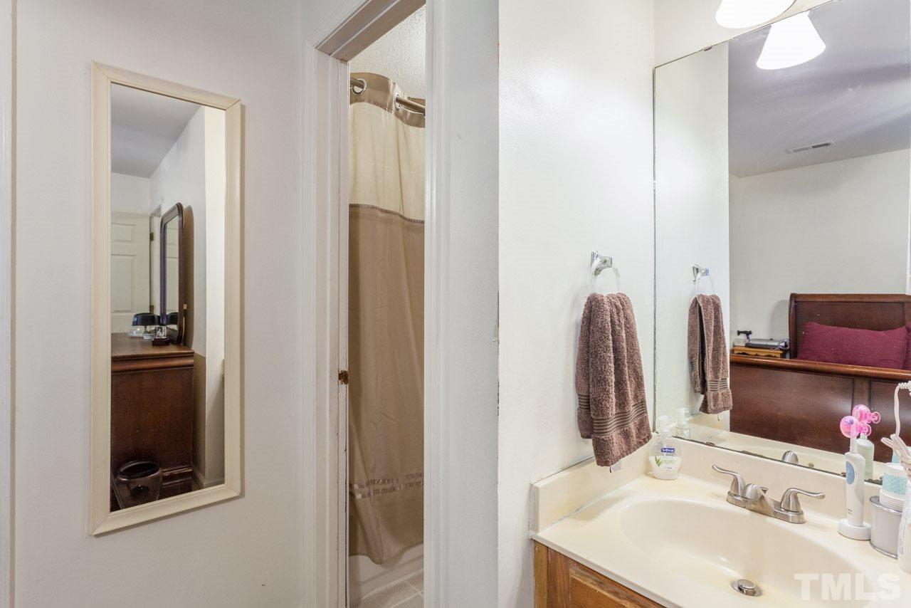 6904 Falls Of Neuse Road, Unit 6904 Raleigh, NC 27615 - Photo 16 of 23 a bathroom with a sink and a mirror