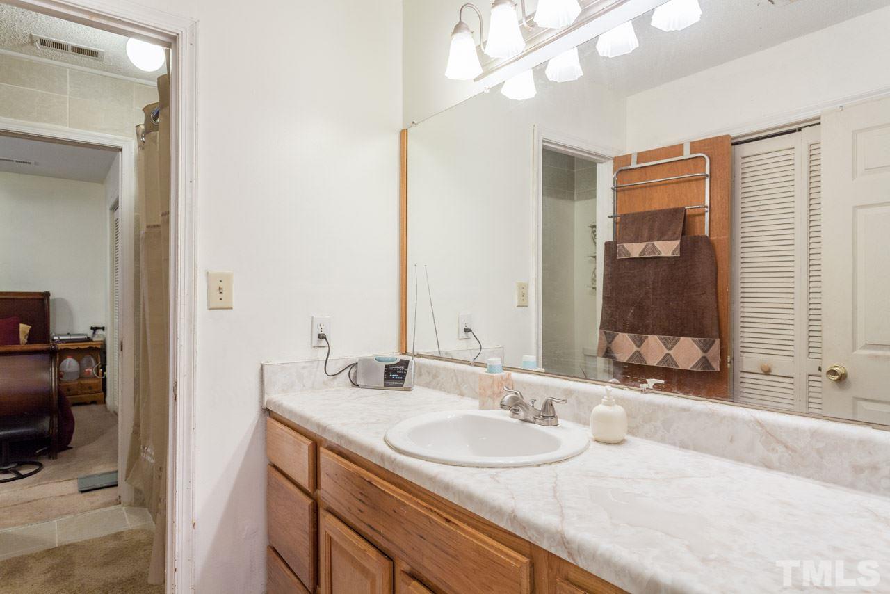 6904 Falls Of Neuse Road, Unit 6904 Raleigh, NC 27615 - Photo 19 of 23 a bathroom with a sink and a mirror
