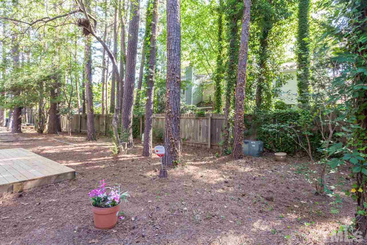 6904 Falls Of Neuse Road, Unit 6904 Raleigh, NC 27615 - Photo 21 of 23 a view of a backyard with trees and plants