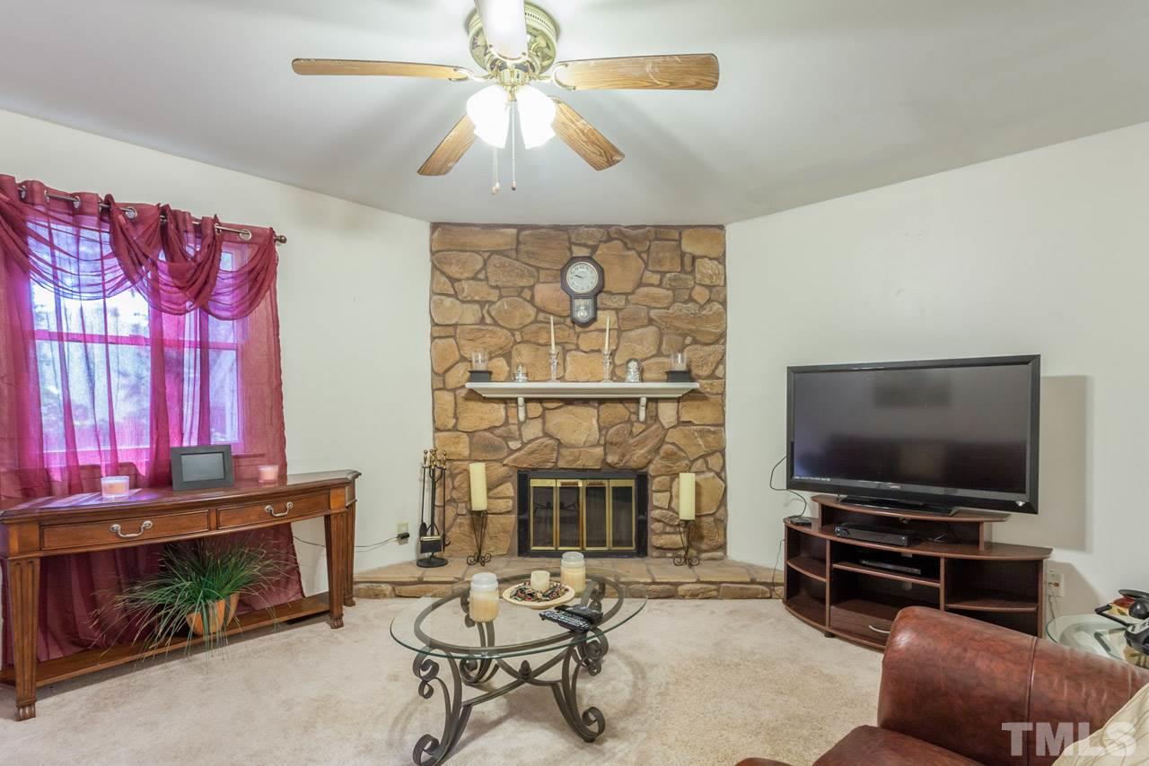 6904 Falls Of Neuse Road, Unit 6904 Raleigh, NC 27615 - Photo 5 of 23 a living room with furniture and a flat screen tv